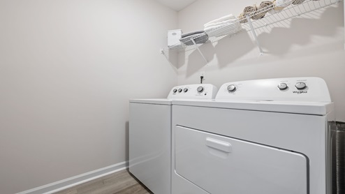 Laundry room with hanging storage racks.