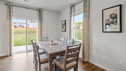 Causal dining area with windows.