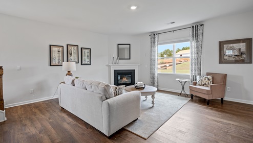 Living area with fireplace and windows.