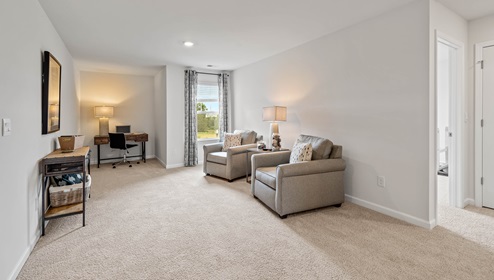 Loft area with carpet and windows.