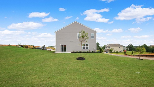 Back exterior with large backyard.
