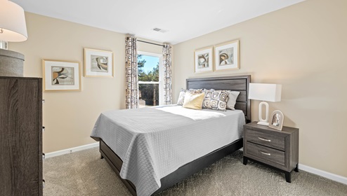 Bedroom with carpet and window.