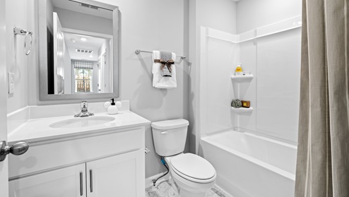 Bathroom with single vanity sink and shower.