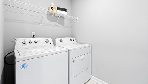 Laundry room with hanging storage racks.