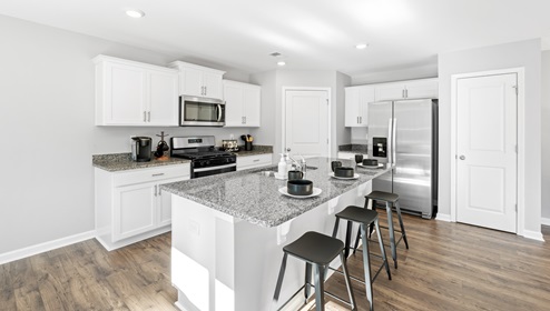 Kitchen and island with granite counter tops.