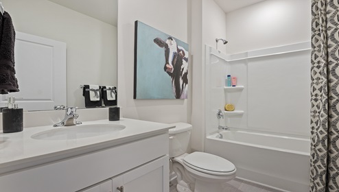 Bathroom with single vanity sink and tub.