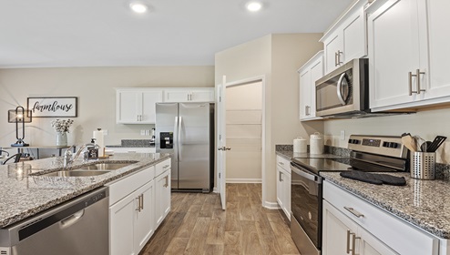 Kitchen and island with granite counter tops.