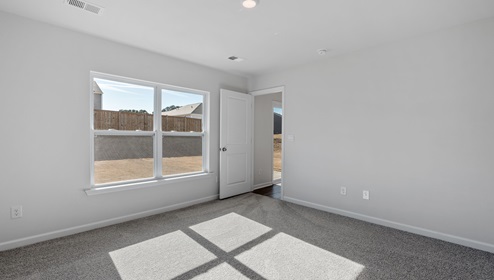 Bedroom with carpet and window.