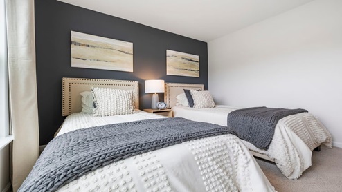 Bedroom with carpet and window.
