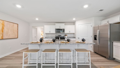 Kitchen and island with granite counter tops.
