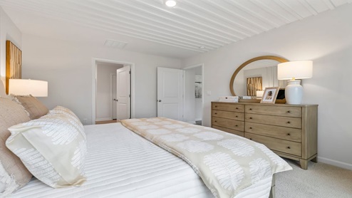 Bedroom with carpet and window.