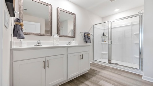 Bathroom with dual vanity sink and shower.