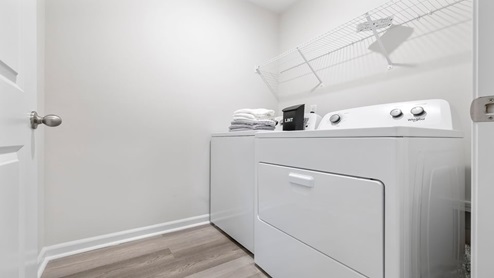 Laundry room with hanging storage racks.