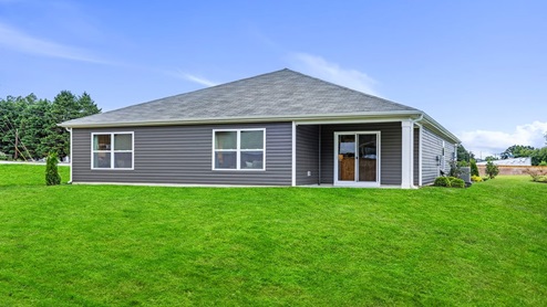 Back exterior of home with large backyard.