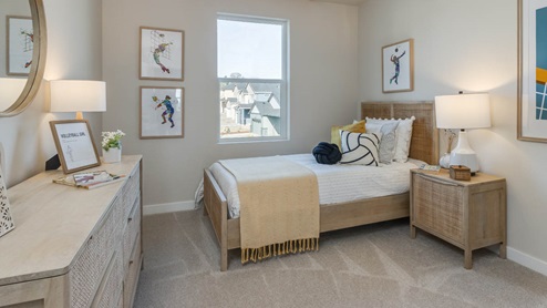 Misty Meadows bedroom with end table, dresser, lights, paintings, and window