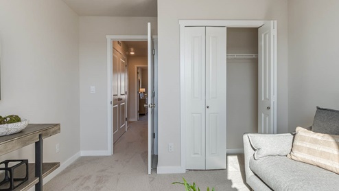 Misty Meadows bedroom with end table and lamp,desk, and closet