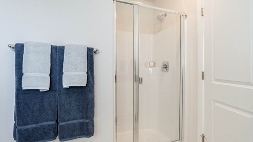 Scholls Meadow primary bathroom with walk in shower and towels