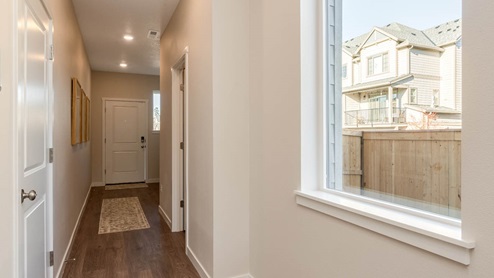 Scholls Meadow Entry with runner rug and laminate flooring, white walls, and window