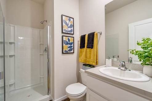 Marcola Meadows Bathroom with single sink vanity and yellow accents