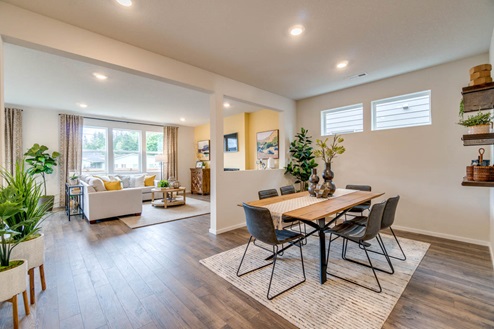 Marcola Meadows dining room with 6 chairs set at the table over an area rug