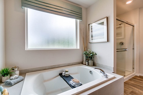 Marcola Meadows Primary Bathroom with double sink vanity, walk in shower, standalone tub, and separate toilet room