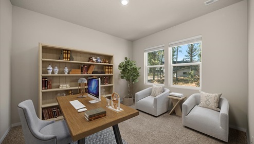 A room with a wooden desk and two accent chairs facing it with a large bookshelf.
