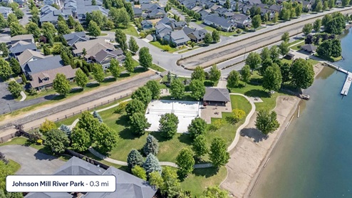 A drone shot of the Spokane River and park down the street from Grand Mill Townhomes