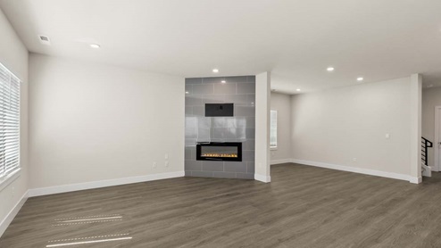 View of Rainier great room showing dining and living space with electric fireplace
