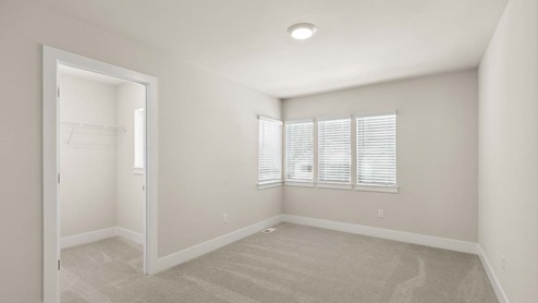 Bedroom 3 with four windows and walk-in closet on upper floor