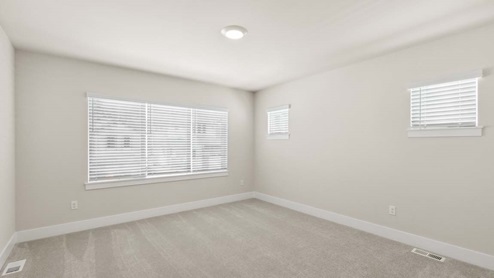 Secondary bedroom with large window and two clerestory windows