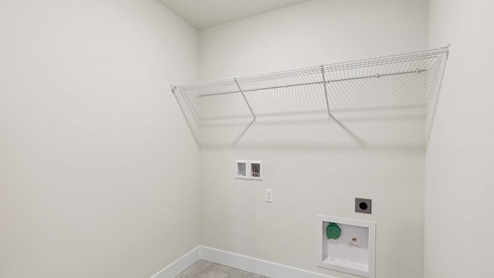 Rainier plan laundry room with washer and dryer hookups and overhead shelf