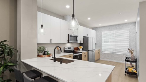 open floor plan kitchen with peninsula pendant lighting