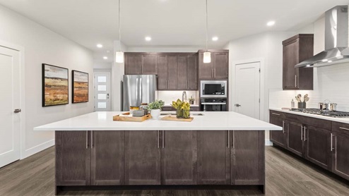 Generous kitchen island counterspace and modern appliances