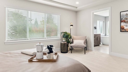 Primary bedroom peeking into the en-suite bathroom
