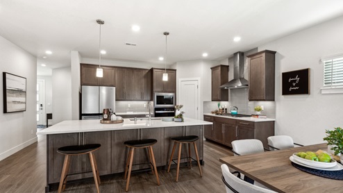 view from dining space into large modern kitchen with modern appliances