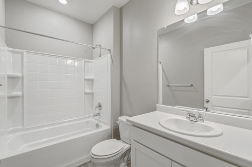 white cabinet bathroom with a bath