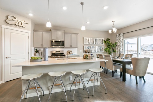 gray cabinet kitchen with ceiling lights, an island and stainless appliances