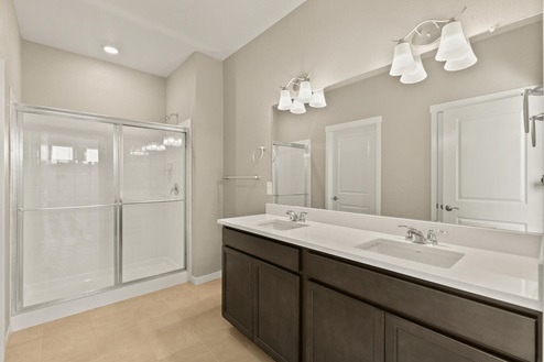 white cabinet bathroom with a shower and dual-basin sink