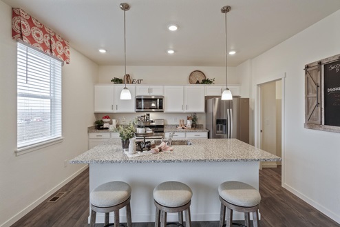 white gray cabinet kitchen with ceiling lights, an island and stainless appliances