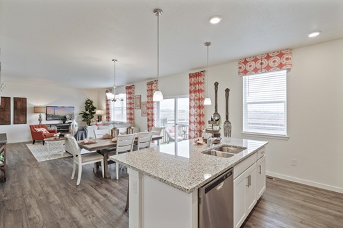 kitchen view of staged living room and dining room an