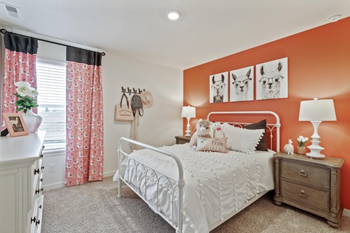 staged bedroom with carpet floor and a window