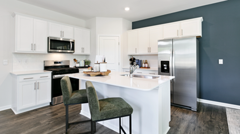kitchen featuring white cabinetry, large island and stainless steel appliances
