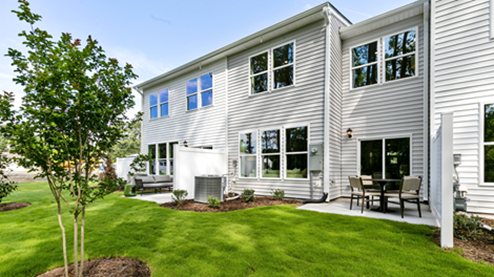Rear exterior of home featuring a privacy fence