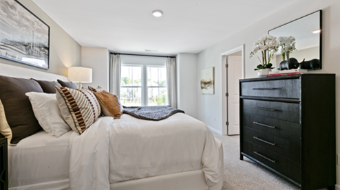 bedroom featuring a large bed, with a large window to the right of it