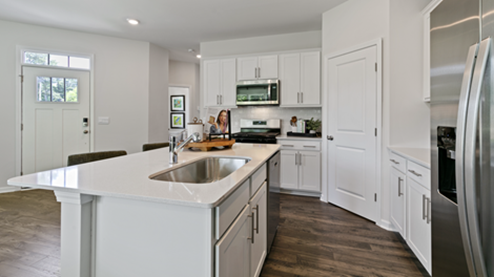 kitchen featuring white cabinetry, large island and stainless steel appliances