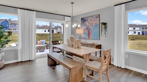 The expansive great room, with an abundance of natural light, flows seamlessly into the dining area.