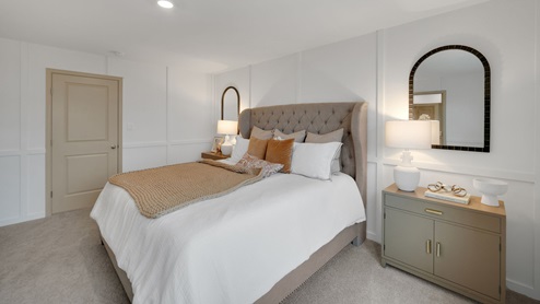 Primary bedroom with a large bed with upholstered headboard flanked by two nightstands.