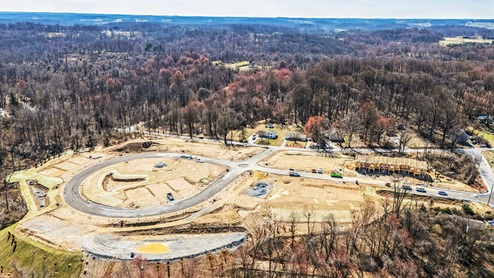 An aerial view looking down at the land development and sitework at Summit Village.