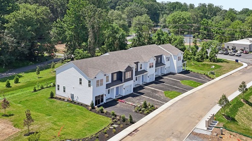 A drone aerial view of the a 7 unit townhome building