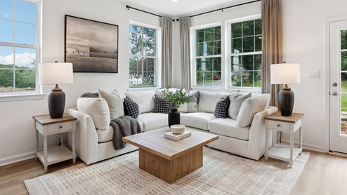First floor living area with three large windows and rear door.